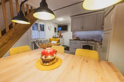 a kitchen with a wooden table with a cake on it at Apartment Zarja - Trije Kralji in Zgornja Ložnica