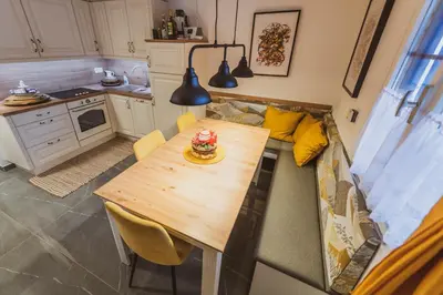 a small kitchen with a table and a couch at Apartment Zarja - Trije Kralji in Zgornja Ložnica