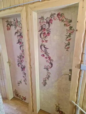 a bathroom with a floral mural on the wall at Koča v gozdu, Forest house near Bled in Bled