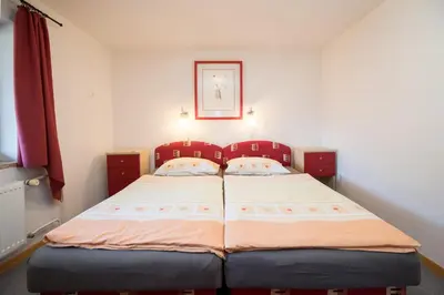 a small bedroom with two beds in it at Apartmaji Hodnik Stara Fužina in Bohinj