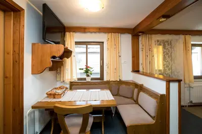 a small room with a table and a couch at Apartmaji Hodnik Stara Fužina in Bohinj