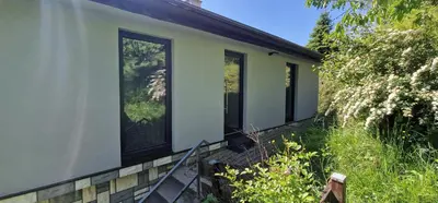 a house with large windows on the side of it at Studio Apartment Aurora in Škofljica