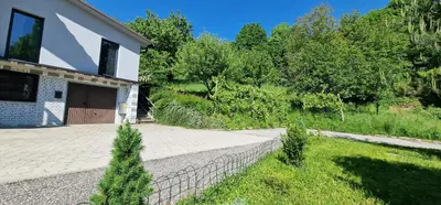 a house with a driveway and a garage at Studio Apartment Aurora in Škofljica