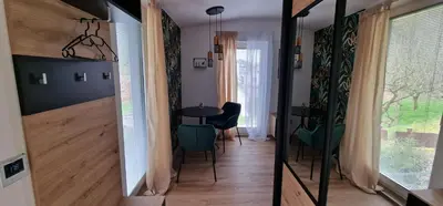 a hallway with a table and chairs in a room at Studio Apartment Aurora in Škofljica