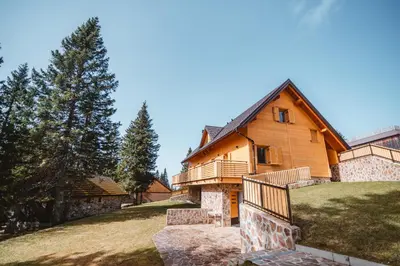 a house on a hill with a staircase in front of it at Rogla Alpina Residence in Zreče