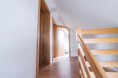 a hallway with wooden stairs in a house at Rogla Alpina Residence in Zreče