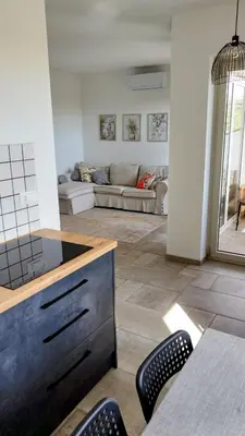 a living room with a couch and a table and chairs at Apartma Lavanda in Kojsko