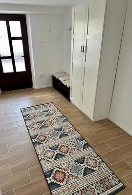 a room with a rug on the floor and a door at Alpine Echo Apartments in Bovec