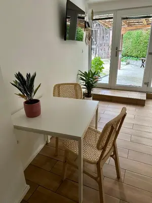 a dining room with a white table and chairs at Alpine Echo Apartments in Bovec