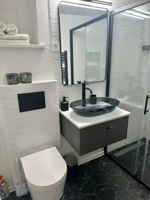 a bathroom with a sink and a toilet and a mirror at Alpine Echo Apartments in Bovec