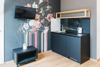 a kitchen with a counter and a wall with a mural at Lilija apartments in Trzin