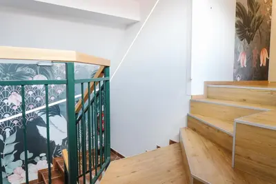 a staircase in a house with a mural on the wall at Lilija apartments in Trzin