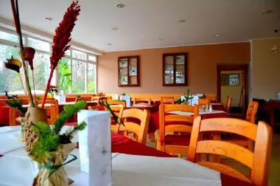 a dining room with tables and chairs at Rooms Barovc by the Lake Jasna in Kranjska Gora