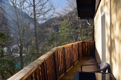 a wooden porch with a bench on a balcony at Rooms Barovc by the Lake Jasna in Kranjska Gora