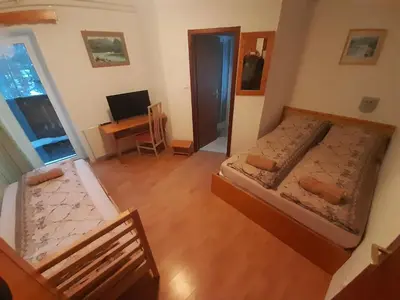 an overhead view of a bedroom with two beds and a desk at Rooms Barovc by the Lake Jasna in Kranjska Gora