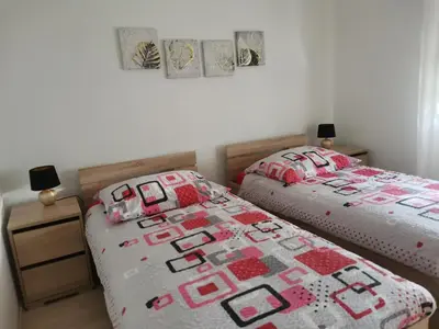 a bedroom with two twin beds and a quilt at Apartment Lošč - Podbela in Breginj