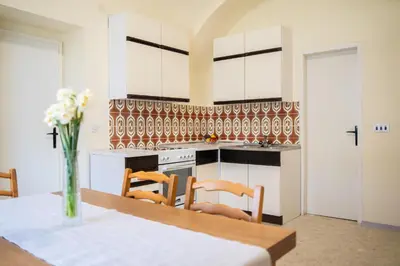 a kitchen with a table and chairs in a room at Apartmaji PAJTLER in Zgornja Kungota