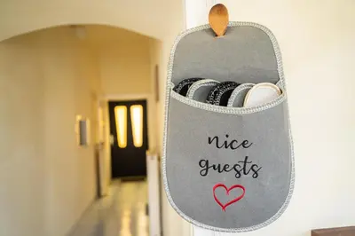 a mirror hanging on a wall with a nice guests sign at Apartmaji PAJTLER in Zgornja Kungota