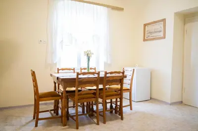 a dining room with a table and chairs and a window at Apartmaji PAJTLER in Zgornja Kungota