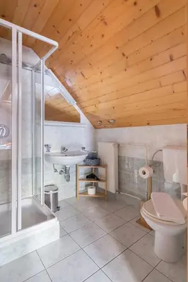 a bathroom with a tub and a toilet and a sink at Apartments Ukanc in Bohinj