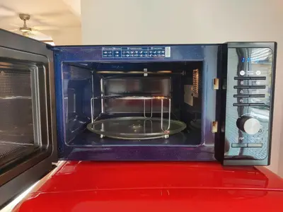 a microwave oven with a plate inside of it at Sunshine apartment Bled in Bled