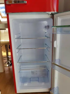 an empty refrigerator with its door open in a kitchen at Sunshine apartment Bled in Bled
