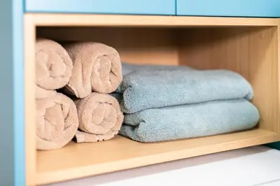 a pile of towels sitting on a shelf at Bubbly Apartment in Bled