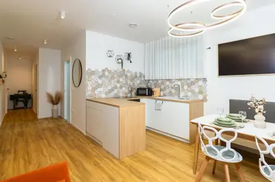 a kitchen and dining room with a table at Bubbly Apartment in Bled
