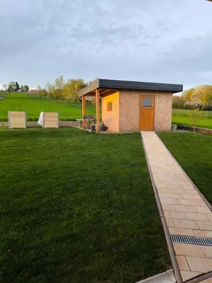 a small house in a field with a grass yard at Hiška Mirna ravnica in Moravske Toplice