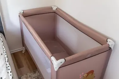 a baby crib in a corner of a room at Apartma Tim Terme Čatež in Čatež ob Savi
