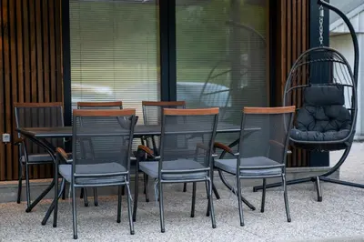 a group of chairs and a table in front of a building at Apartma Tim Terme Čatež in Čatež ob Savi