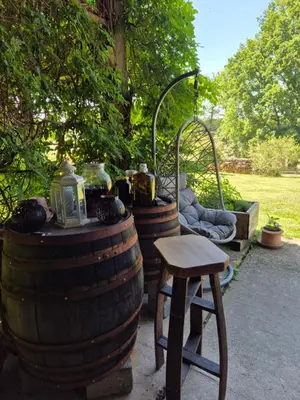 two large wine barrels with a stool and a table at Apartma Župelefski raj in Kapele