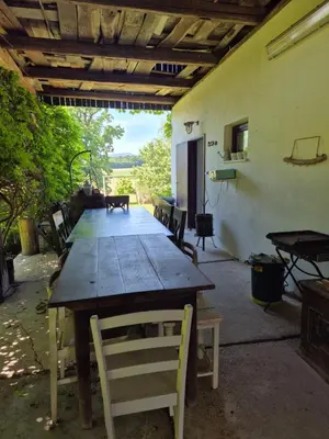 a large wooden table with chairs in a room at Apartma Župelefski raj in Kapele