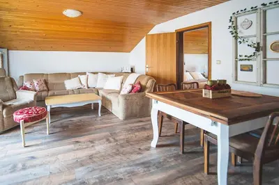 a living room with a couch and a table at Apartma Župelefski raj in Kapele