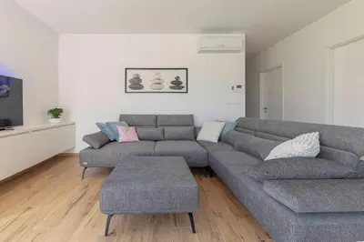 a living room with a couch and a table at Apartment Bela Bovec in Bovec