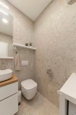 a bathroom with a white toilet and a sink at Apartment Bela Bovec in Bovec