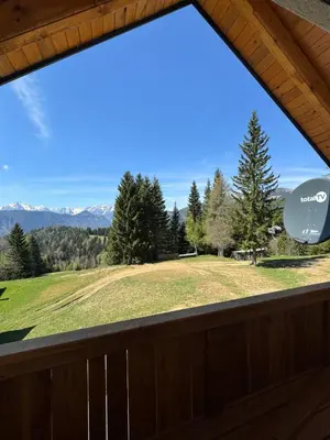 a view from the deck of a cabin with a large window at Špan Cottage in Jesenice