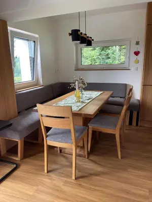 a dining room with a wooden table and chairs at Špan Cottage in Jesenice