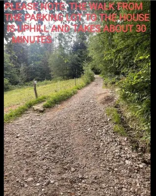 a dirt road with the words increase more the walk from any institution to the house at Špan Cottage in Jesenice