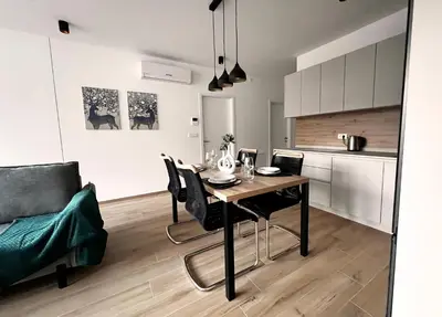 a kitchen and dining room with a table and chairs at Alpine Haven in Bovec