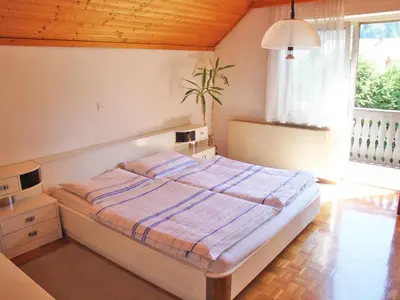a bedroom with a large bed in a room at Apartments Ana Kranjska Gora in Kranjska Gora