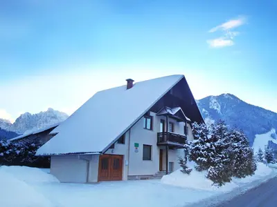 a house with a roof covered in snow at Apartments Ana Kranjska Gora in Kranjska Gora