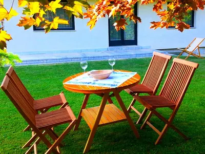 a table and two chairs with a bowl and wine glasses at Apartments Ana Kranjska Gora in Kranjska Gora