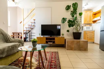 a living room with a couch and a tv at APARTMA ENI in Moravske Toplice