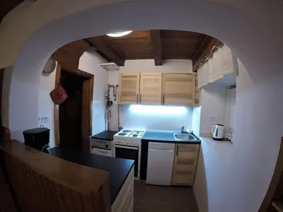 a kitchen with an archway in the middle of it at Holiday House Damjana (Hiška Damjana), Ukanc, Bohinjsko jezero in Bohinj
