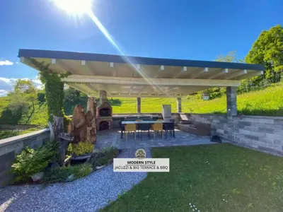 a pergola with a table and chairs under it at Apartmaji Paletino in Turjak