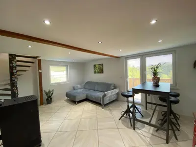 a living room with a couch and a table at Apartmaji Paletino in Turjak