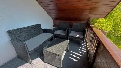 two chairs and a table on a balcony at Secret Paradise apartment in Zgornje Gorje