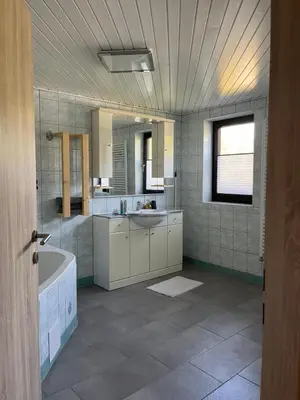 a large bathroom with a tub and a sink at Secret Paradise apartment in Zgornje Gorje