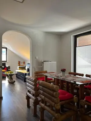 a living room with a dining room table and chairs at Secret Paradise apartment in Zgornje Gorje